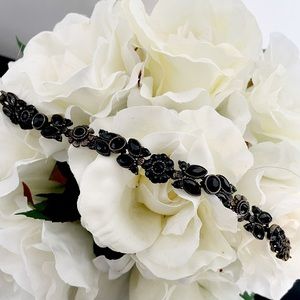 Pewter bracelet w/ black beading in floral design.
